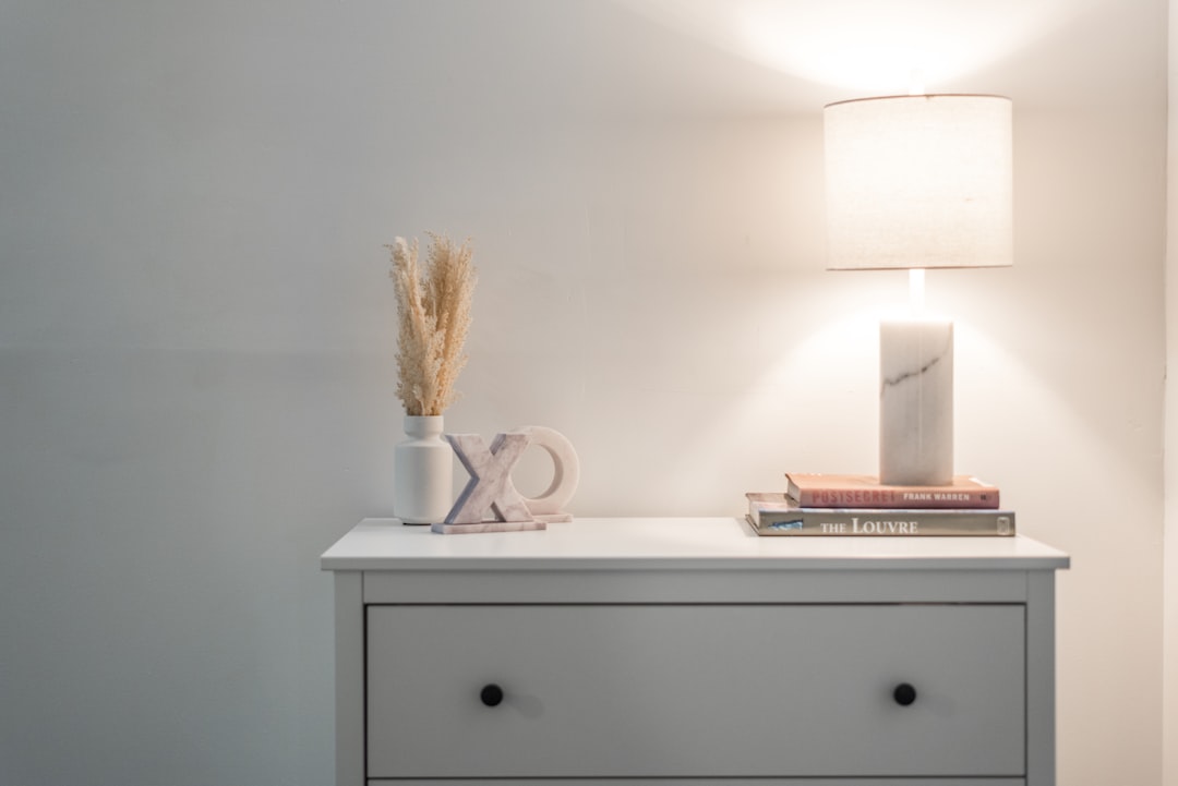 services-03 a-nightstand-with-a-lamp-and-books-on-top-of-it-mi3fq8eibys